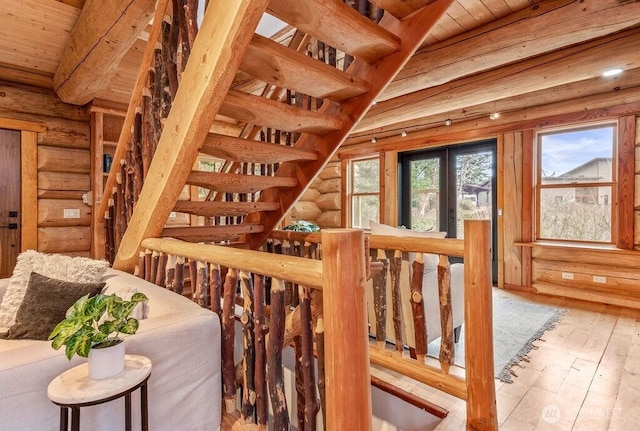 interior space featuring wood ceiling, beam ceiling, a wealth of natural light, and wood finished floors