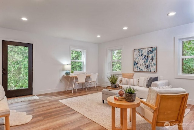 living room featuring recessed lighting, light wood-style flooring, and baseboards