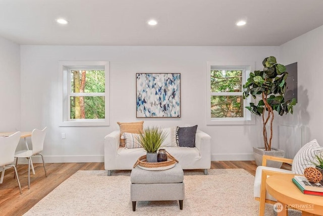 sitting room with light wood-type flooring, baseboards, and recessed lighting