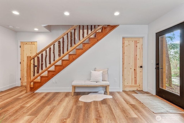 entryway featuring light wood-type flooring, stairway, baseboards, and recessed lighting