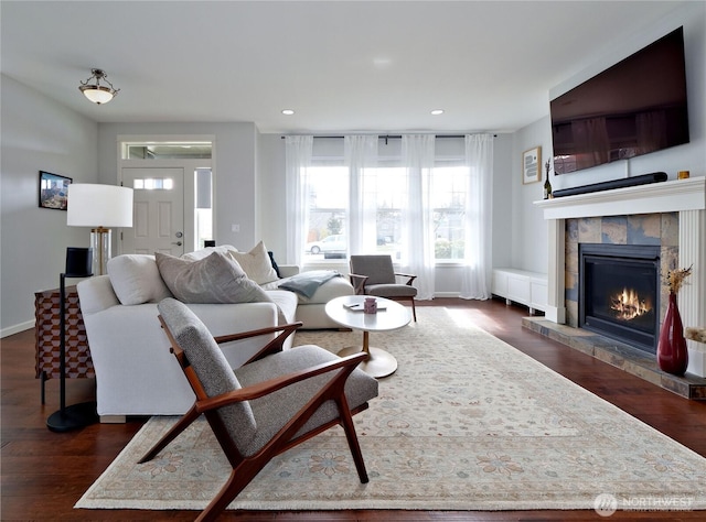 living room with dark wood finished floors, recessed lighting, a fireplace, and baseboards