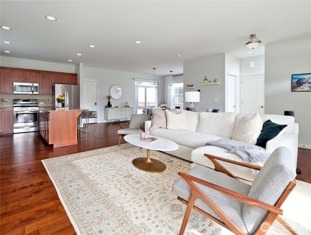 living area with dark wood finished floors and recessed lighting