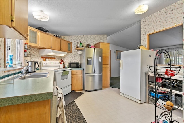 kitchen featuring sink, white appliances, and a textured ceiling