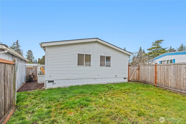 rear view of property with a yard