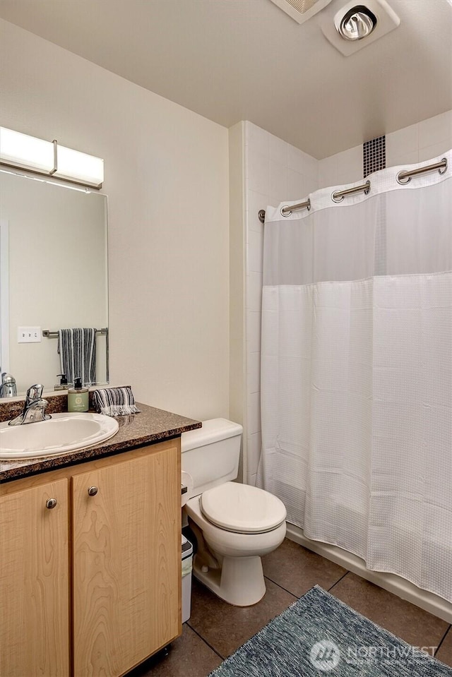 full bathroom with tile patterned floors, vanity, toilet, and shower / tub combo