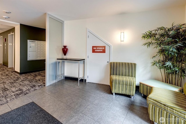 living area with tile patterned floors and a mail area