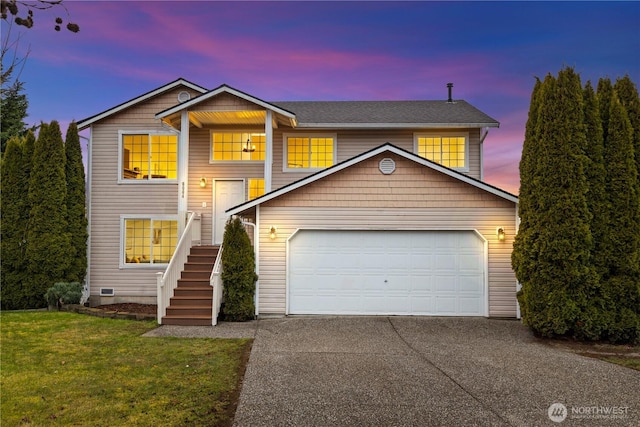 view of front facade with a garage and a lawn