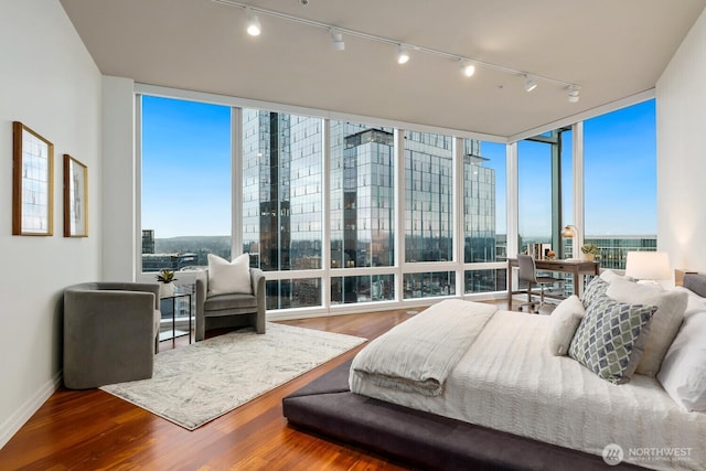 bedroom featuring hardwood / wood-style floors and expansive windows