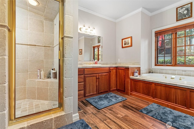 bathroom with plenty of natural light, crown molding, wood finished floors, and a shower stall