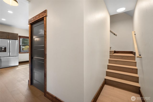 stairs with recessed lighting, baseboards, and wood finished floors