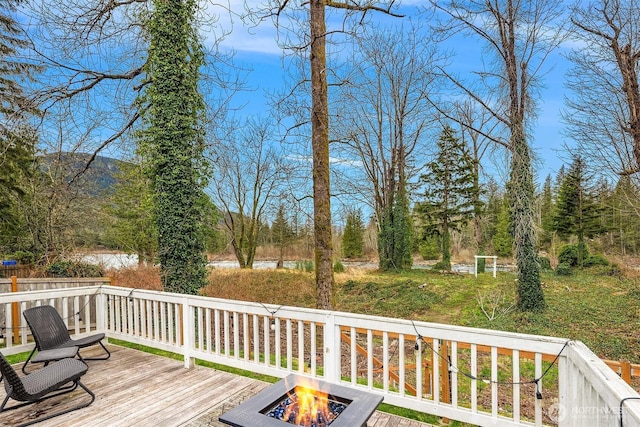 wooden deck with an outdoor fire pit