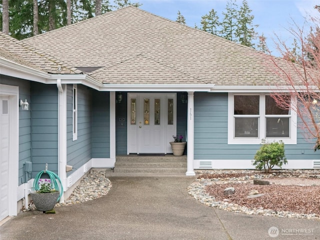 property entrance with crawl space, a shingled roof, and a garage