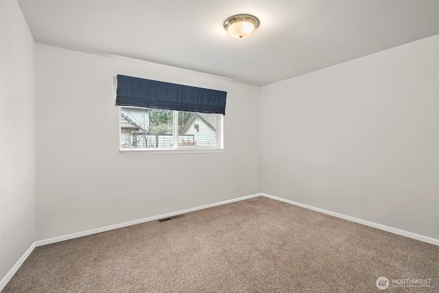 carpeted empty room with visible vents and baseboards