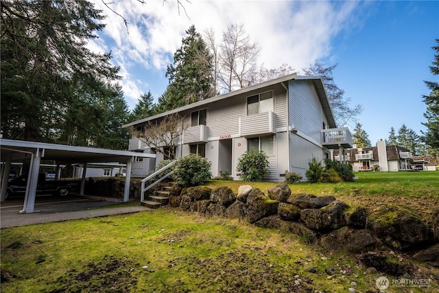 view of front of home with a front lawn and a carport