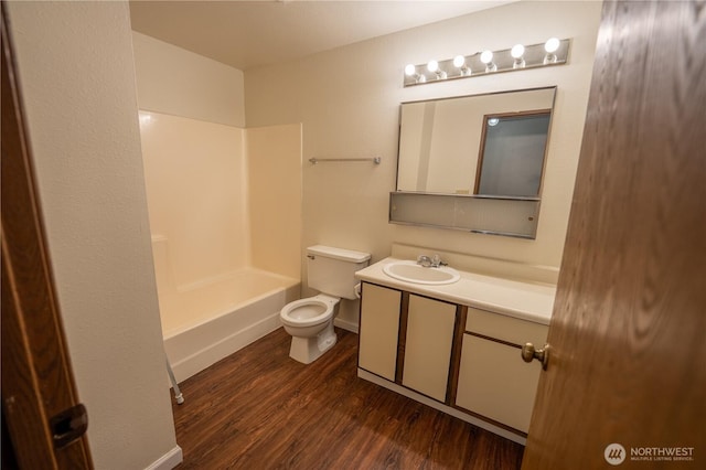 bathroom featuring vanity, shower / tub combination, wood finished floors, and toilet