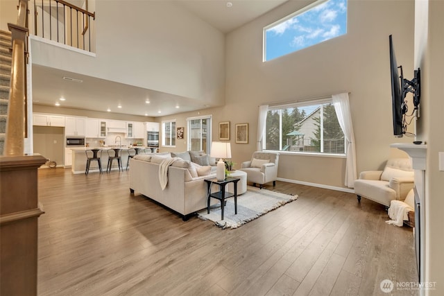 living room featuring sink and light wood-type flooring