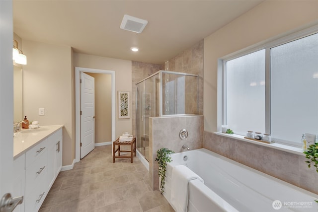 bathroom with vanity and independent shower and bath