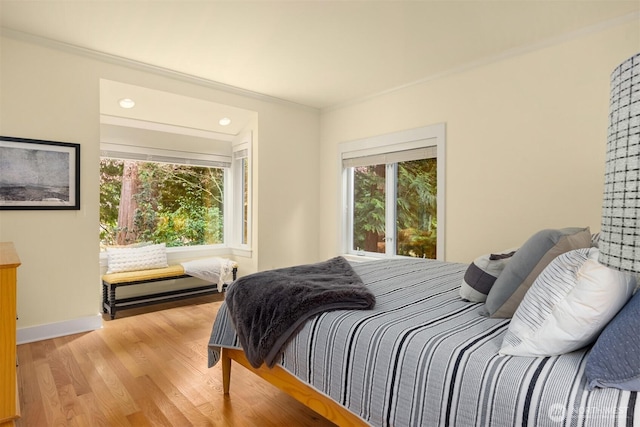 bedroom with hardwood / wood-style flooring and crown molding