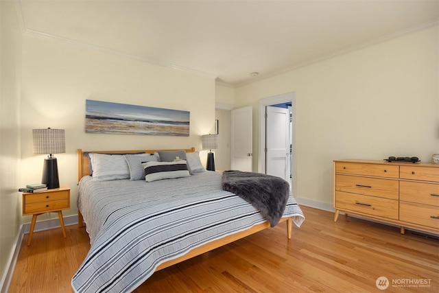 bedroom with ornamental molding and light hardwood / wood-style flooring