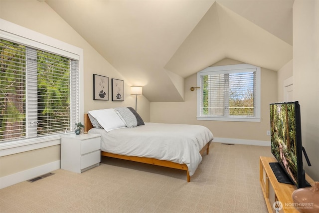 carpeted bedroom featuring lofted ceiling