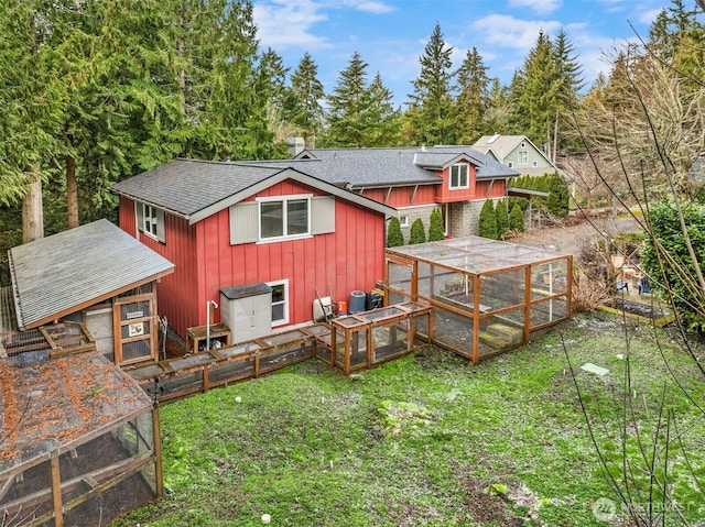 back of house featuring an outbuilding