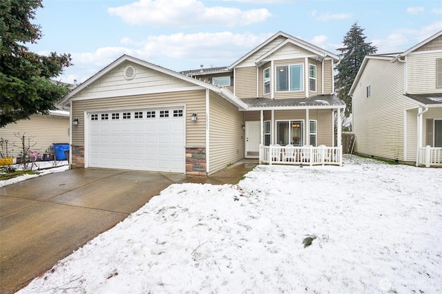 view of front of property featuring covered porch, driveway, stone siding, and a garage