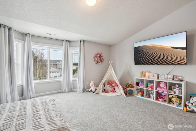 game room with lofted ceiling, a textured ceiling, and carpet flooring