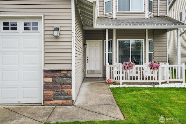 entrance to property with roof with shingles and a porch