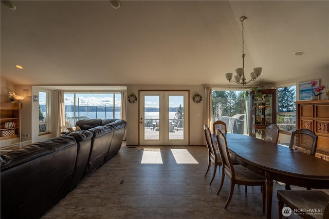 dining space featuring a notable chandelier and lofted ceiling