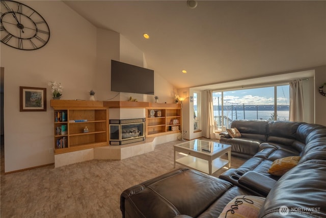 living room with recessed lighting, high vaulted ceiling, and a tiled fireplace