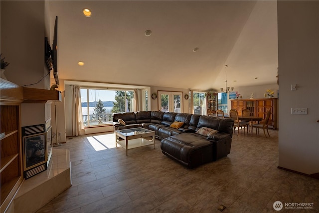 living room with high vaulted ceiling and a fireplace