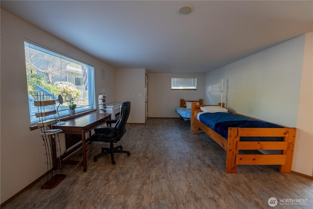 bedroom featuring baseboards and wood finished floors