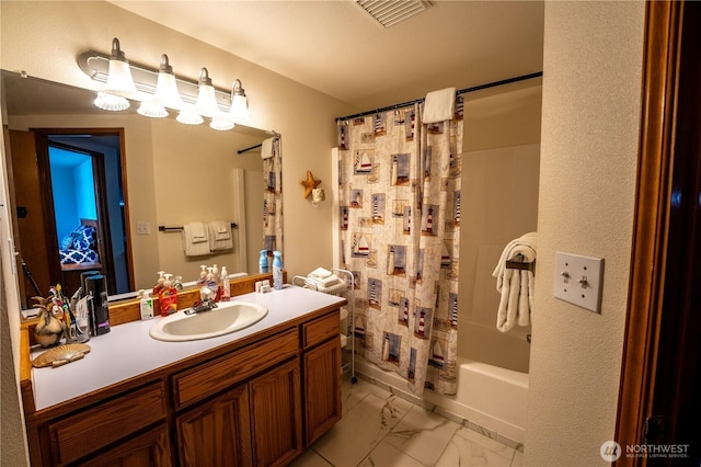 full bath with visible vents, shower / tub combo with curtain, marble finish floor, and vanity