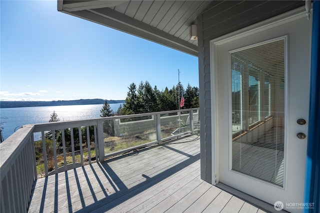 wooden deck featuring a water view