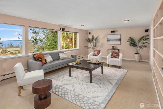 living area featuring baseboard heating and baseboards