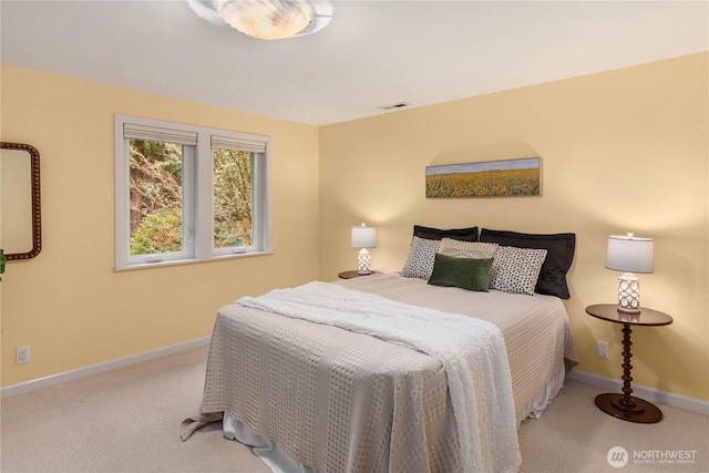 carpeted bedroom with visible vents and baseboards