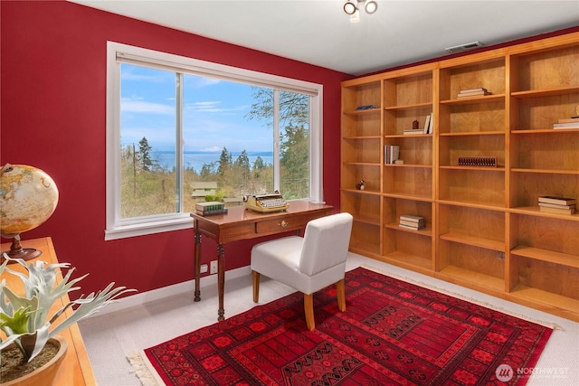 home office with baseboards, visible vents, and carpet floors