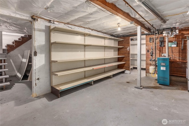 unfinished basement with a heating unit and stairs