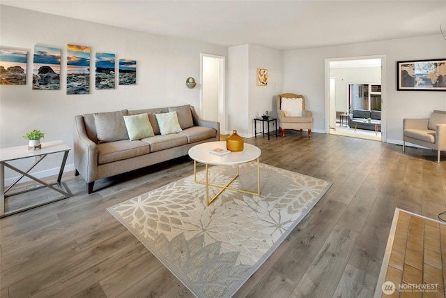 living room featuring baseboards and wood finished floors