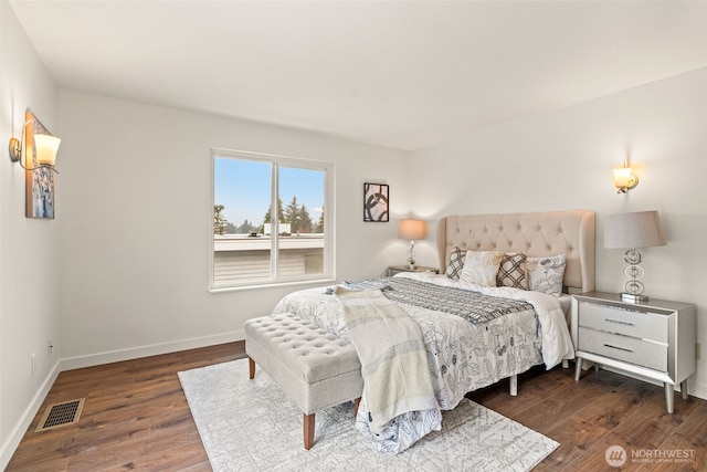 bedroom with dark hardwood / wood-style floors