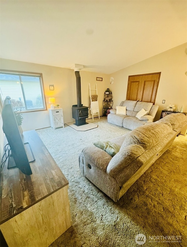 living area featuring carpet floors and a wood stove