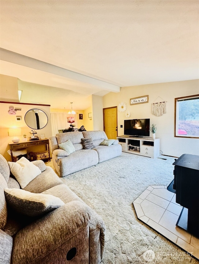 carpeted living area with lofted ceiling with beams