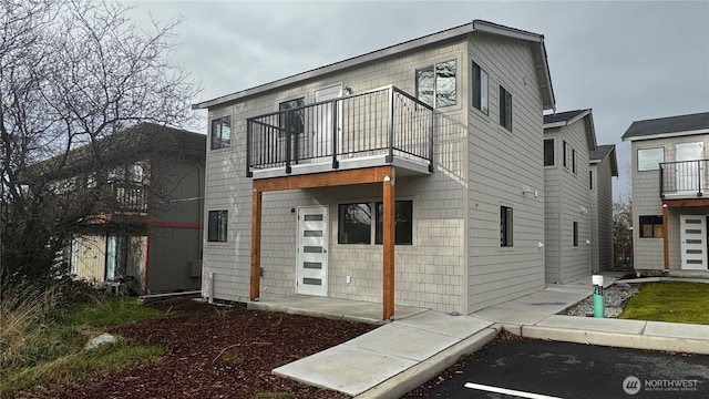 rear view of house featuring a balcony