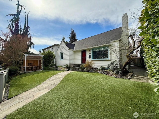 view of front facade featuring a chimney, a front lawn, and fence