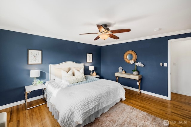 bedroom featuring ornamental molding, wood finished floors, and baseboards