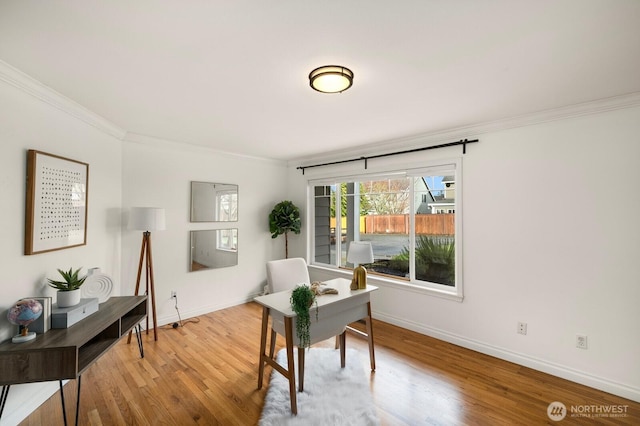 home office with ornamental molding, wood finished floors, and baseboards