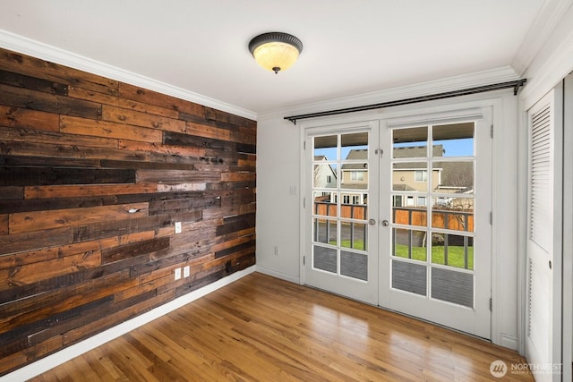 entryway featuring ornamental molding, french doors, baseboards, and wood finished floors