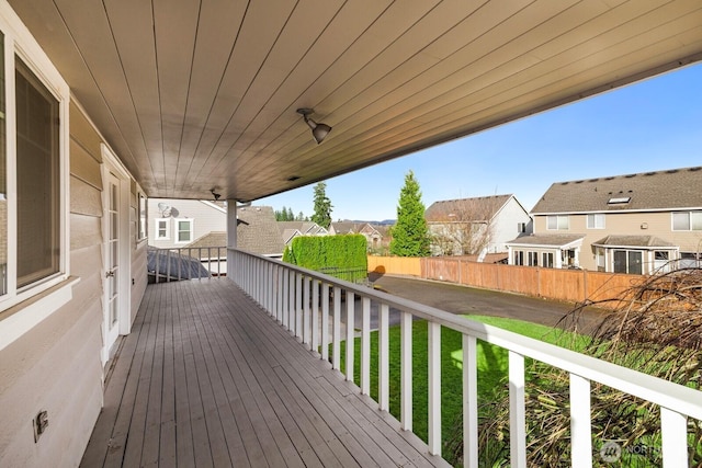 wooden deck with a residential view and fence