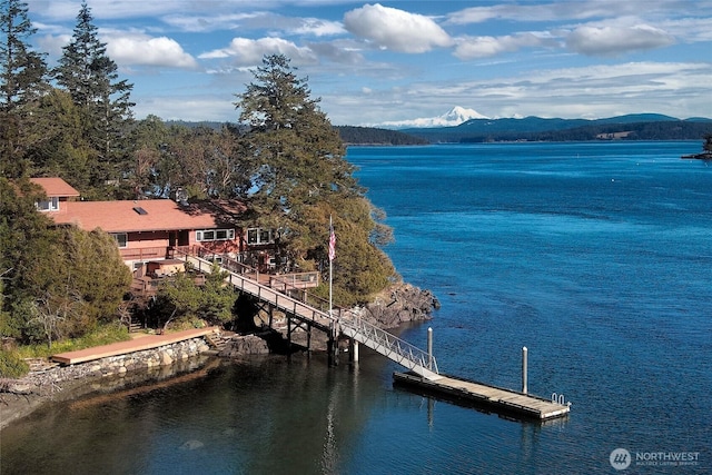 view of water feature with a mountain view and a boat dock