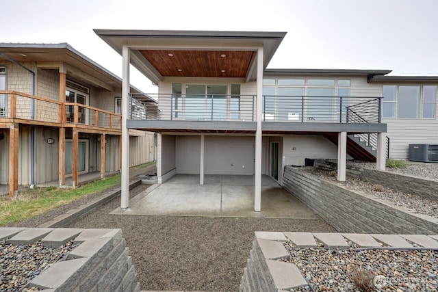 rear view of property featuring central air condition unit and a patio area